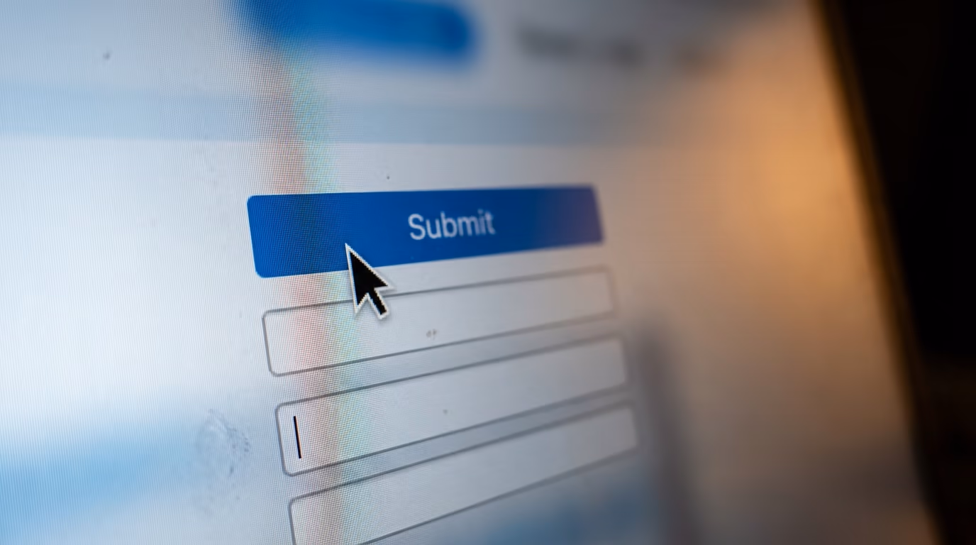 Best AI model for computer use, a mouse cursor resting on a blue Submit button on a screen