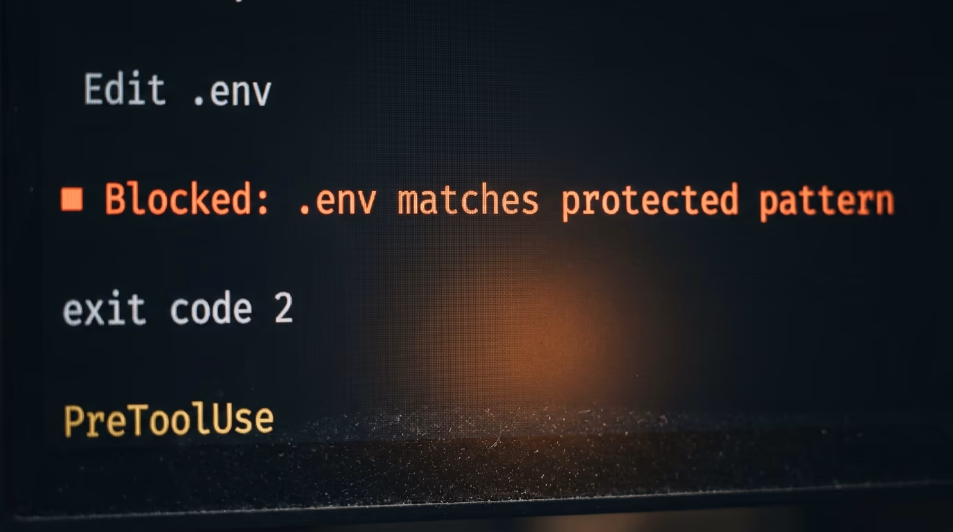 A terminal showing a Claude Code hook blocking an edit to a .env file