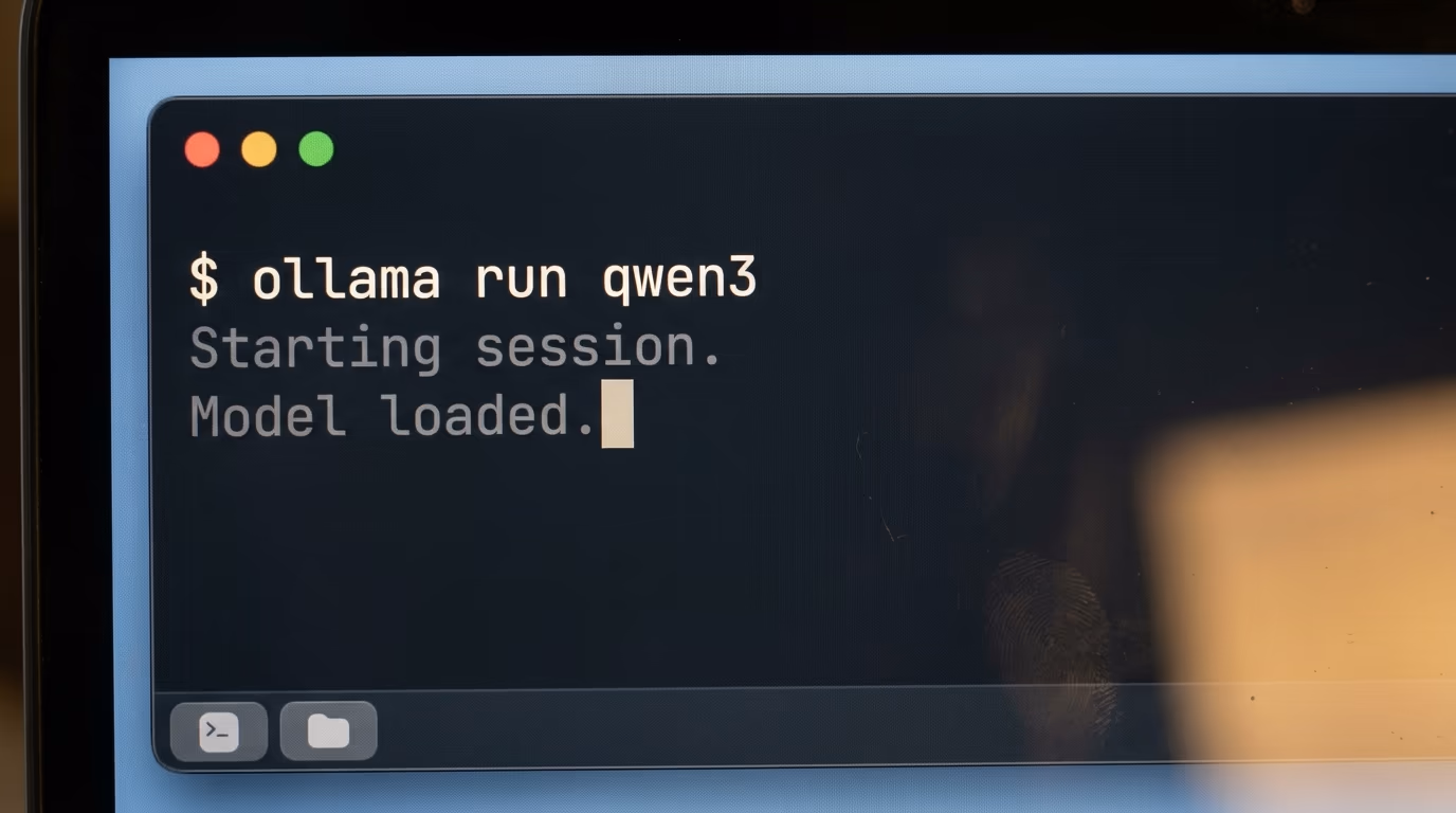 A laptop screen showing a terminal running a local model with the ollama run command visible