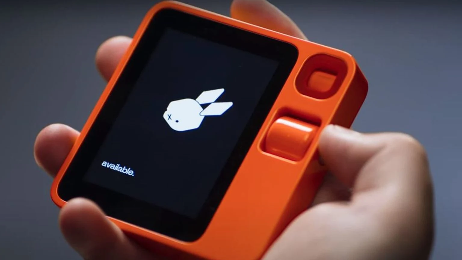 The rabbit r1 held in a hand, the pocket AI device the Meta Muse Charm most resembles
