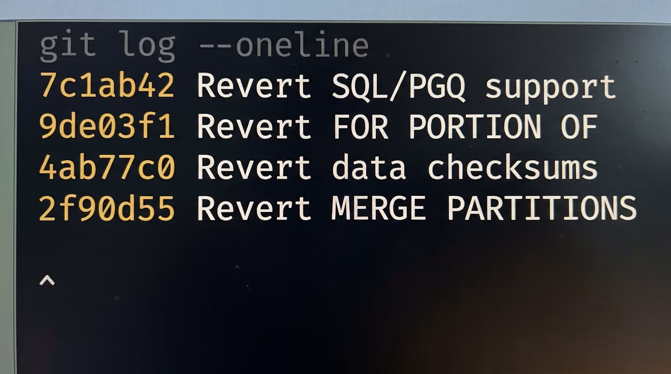 A git history listing revert commits for PostgreSQL features taken back out before release